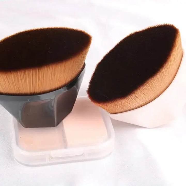 a couple of makeup brushes sitting on top of a container